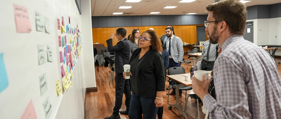 Faculty and Staff writing on a white board