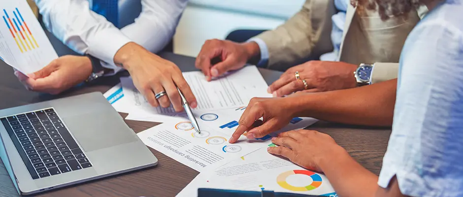 Stock image of people looking at data sheets